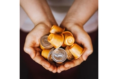 Image Hands holding coffee capsules.